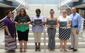 First row, from left, are SECU Board Member Doris Joseph; SECU Scholarship Recipients Angelica Hinson, Chimere Young, Esther Jayroe and Jennifer Barnes; and SECU Board Member Lynne Spaulding. Not pictured are Scholarship Recipients Haley Collins, Morgan Oxendine, Dakota Perkins, Jolly Ann Quino, Candace Sellers and Caitlyn Soles.